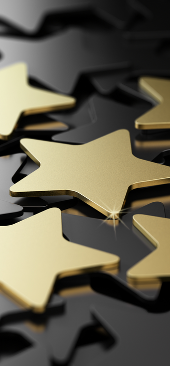 Goldene Sterne liegen auf schwarzem Hintergrund