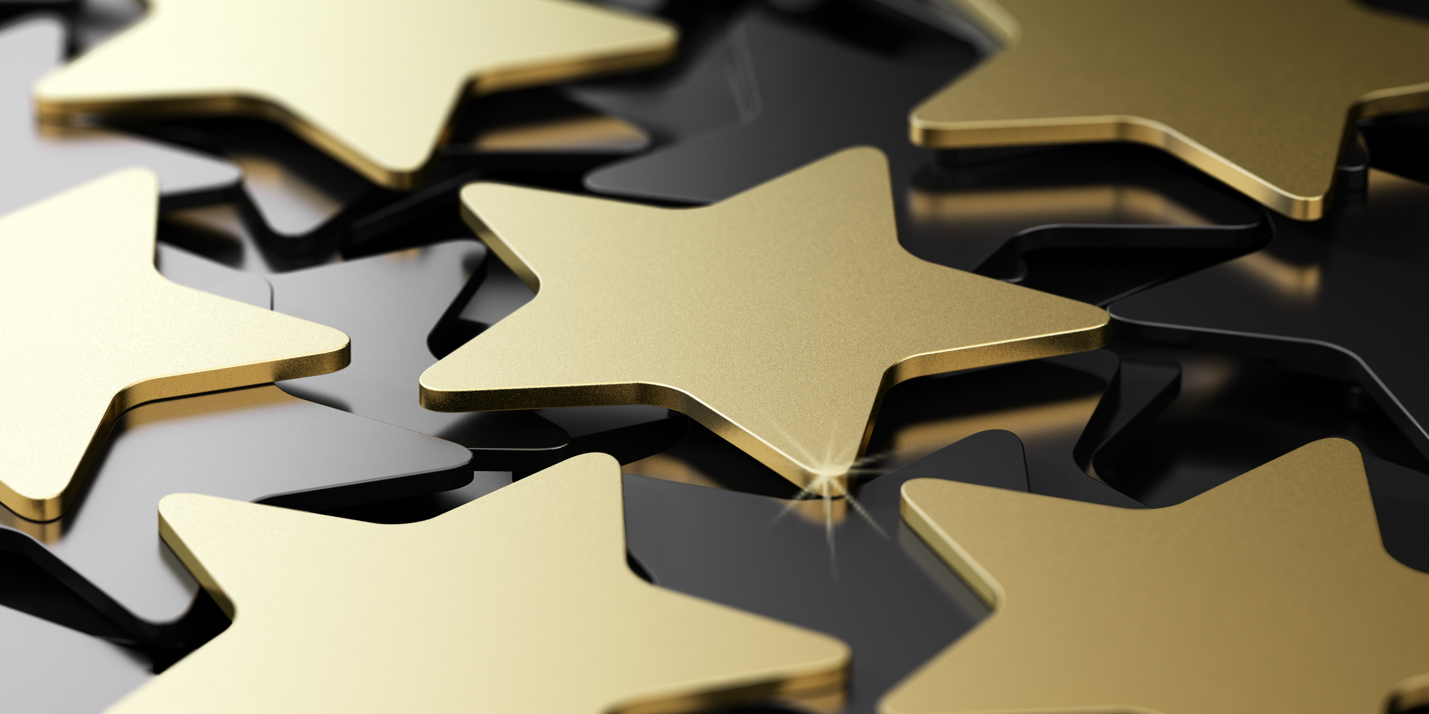 Goldene Sterne liegen auf schwarzem Hintergrund